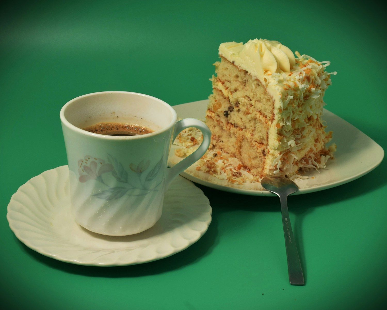 A slice of cake with a cup of coffee